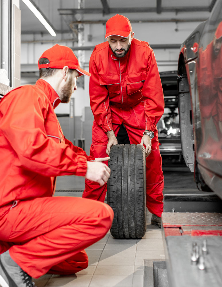 Workers changing wheels at the car service 2021 11 12 23 09 03 utc.jpg